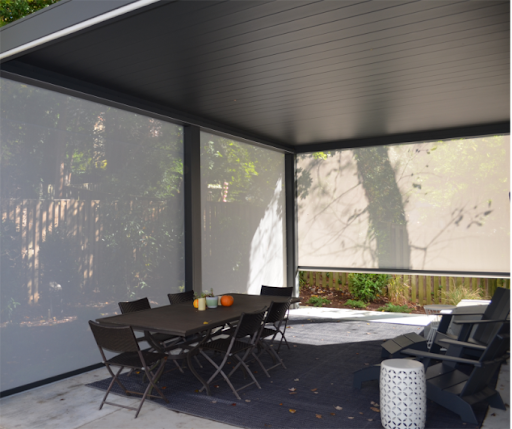 Motorized pergola with fully closed adjustable louvers and protective side panels, providing maximum shade and privacy for custom outdoor comfort.